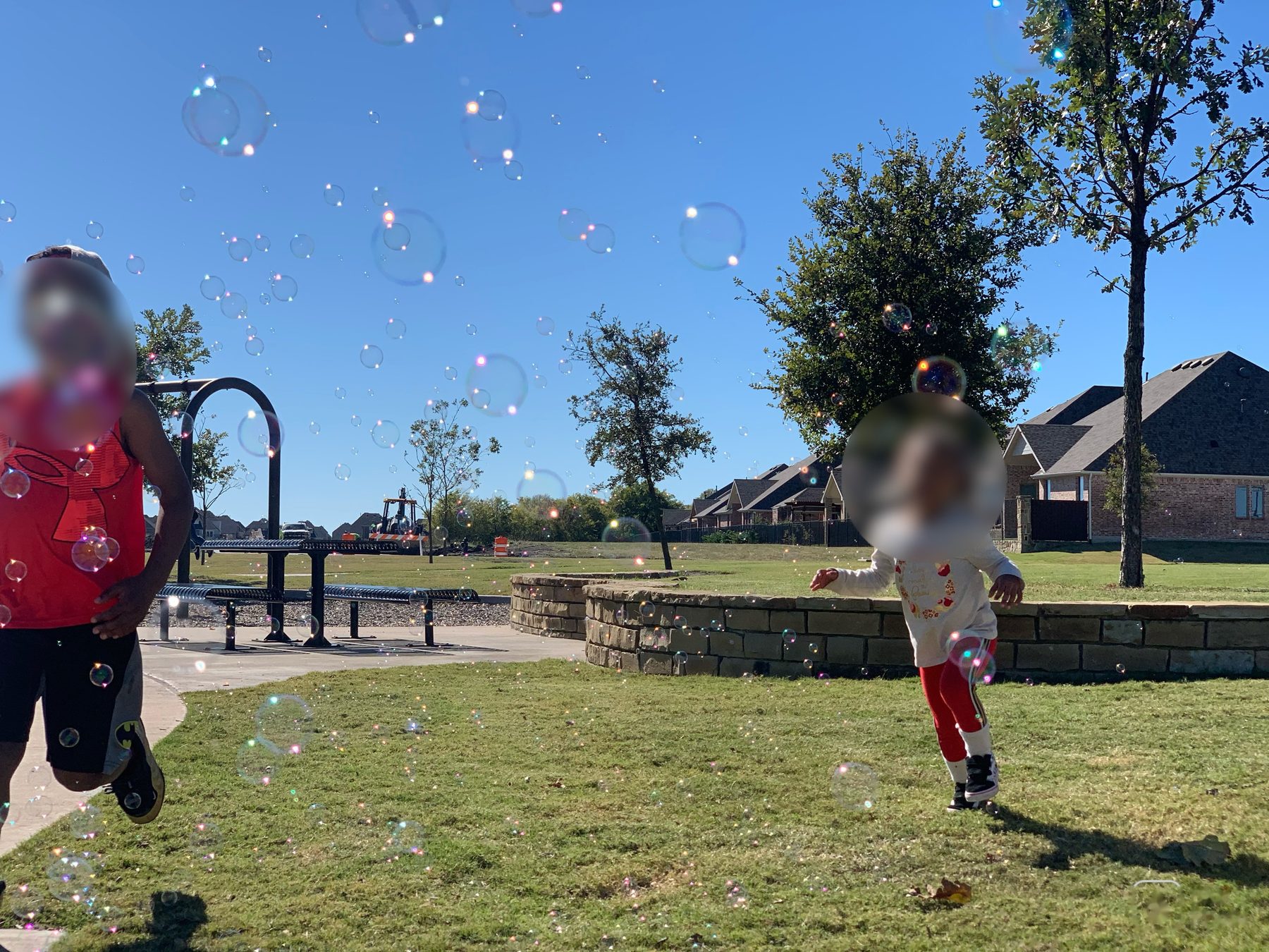 Outdoor play — bubble chasing at the park