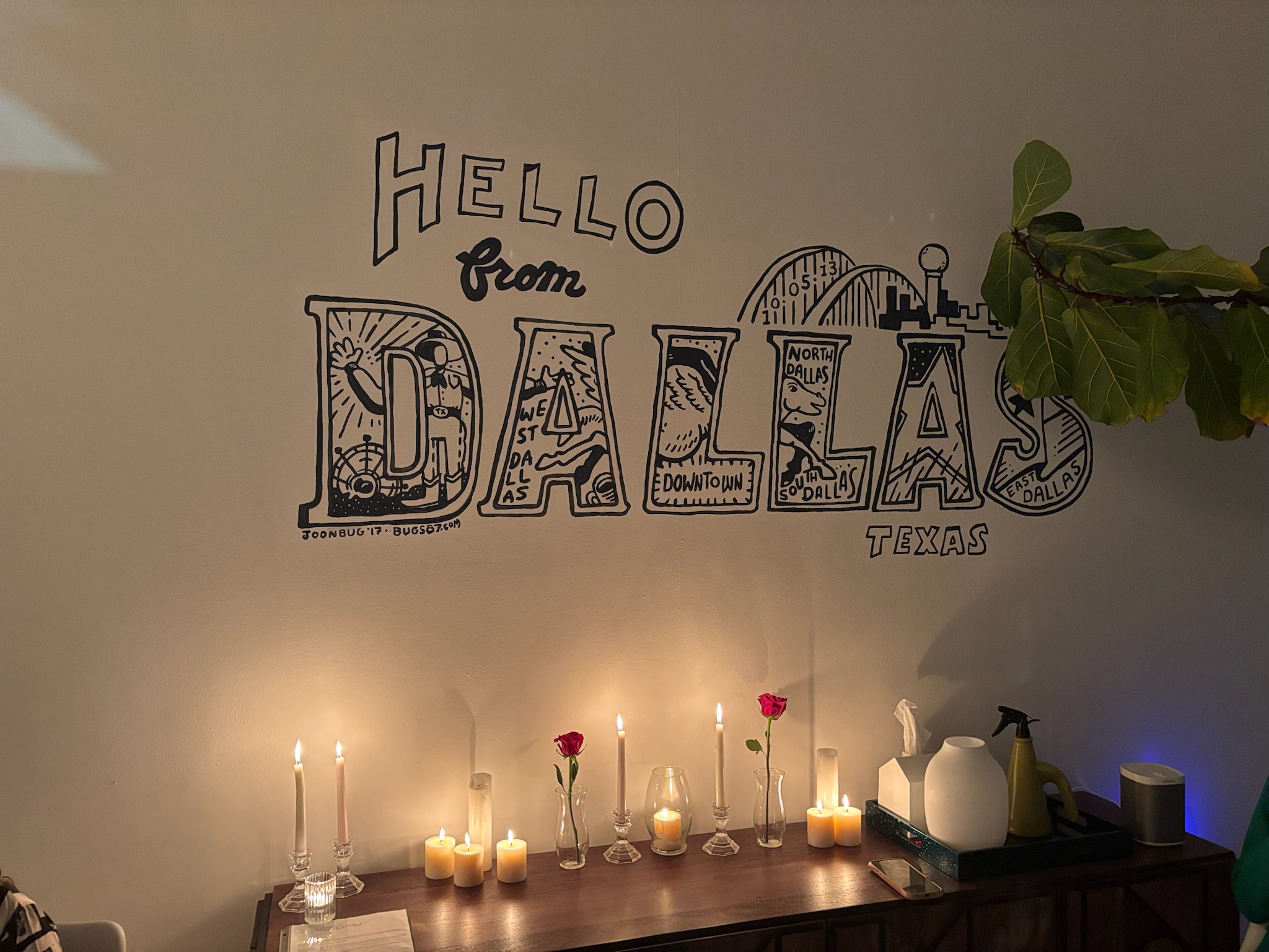 The Hello from Dallas mural at The Office On Perry with candles and a single rose