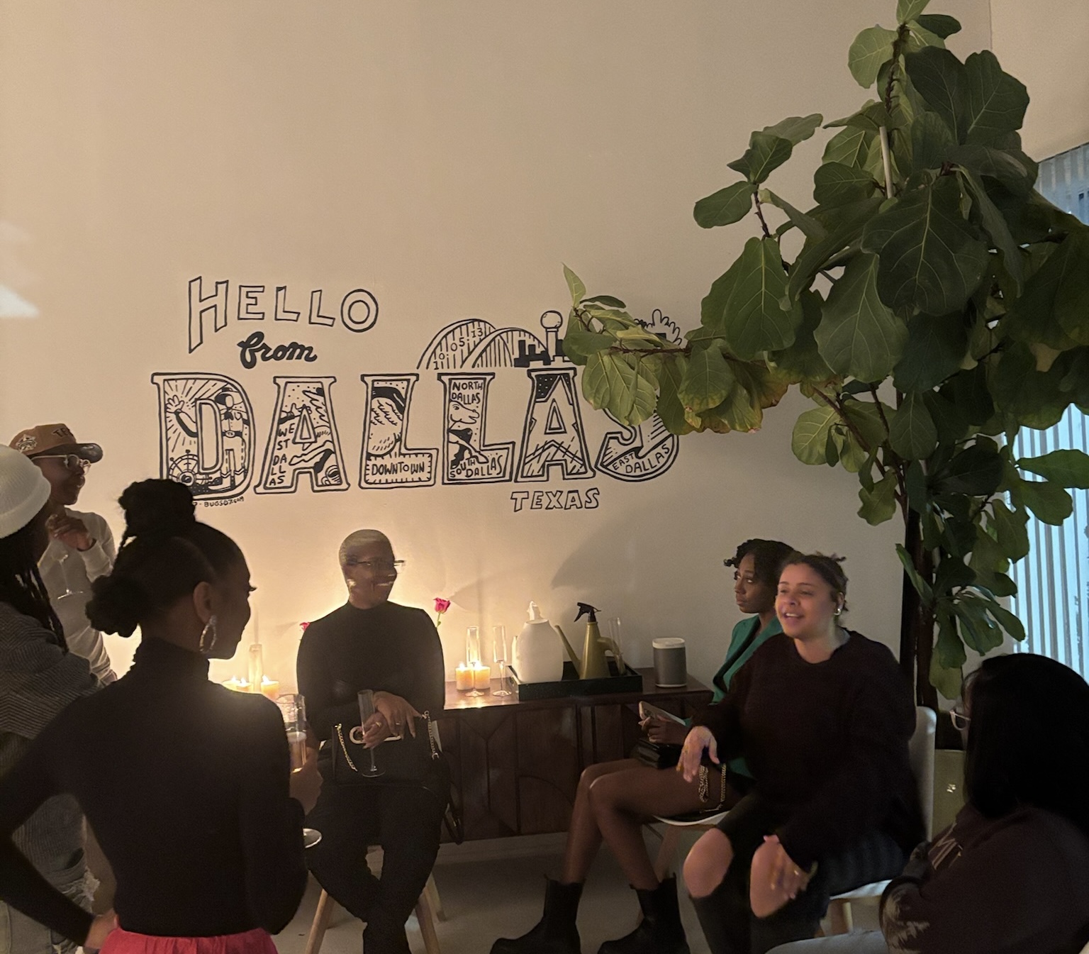 Guests seated and in conversation during the opening of Shots Fired on Valentine St.
